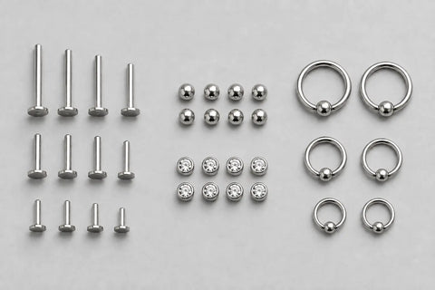 Titanium posts, matching ends and rings grouped by component and size for studio restock planning.
