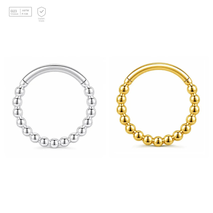 Beaded Orbit titanium segment ring in natural titanium and gold-plated finishes